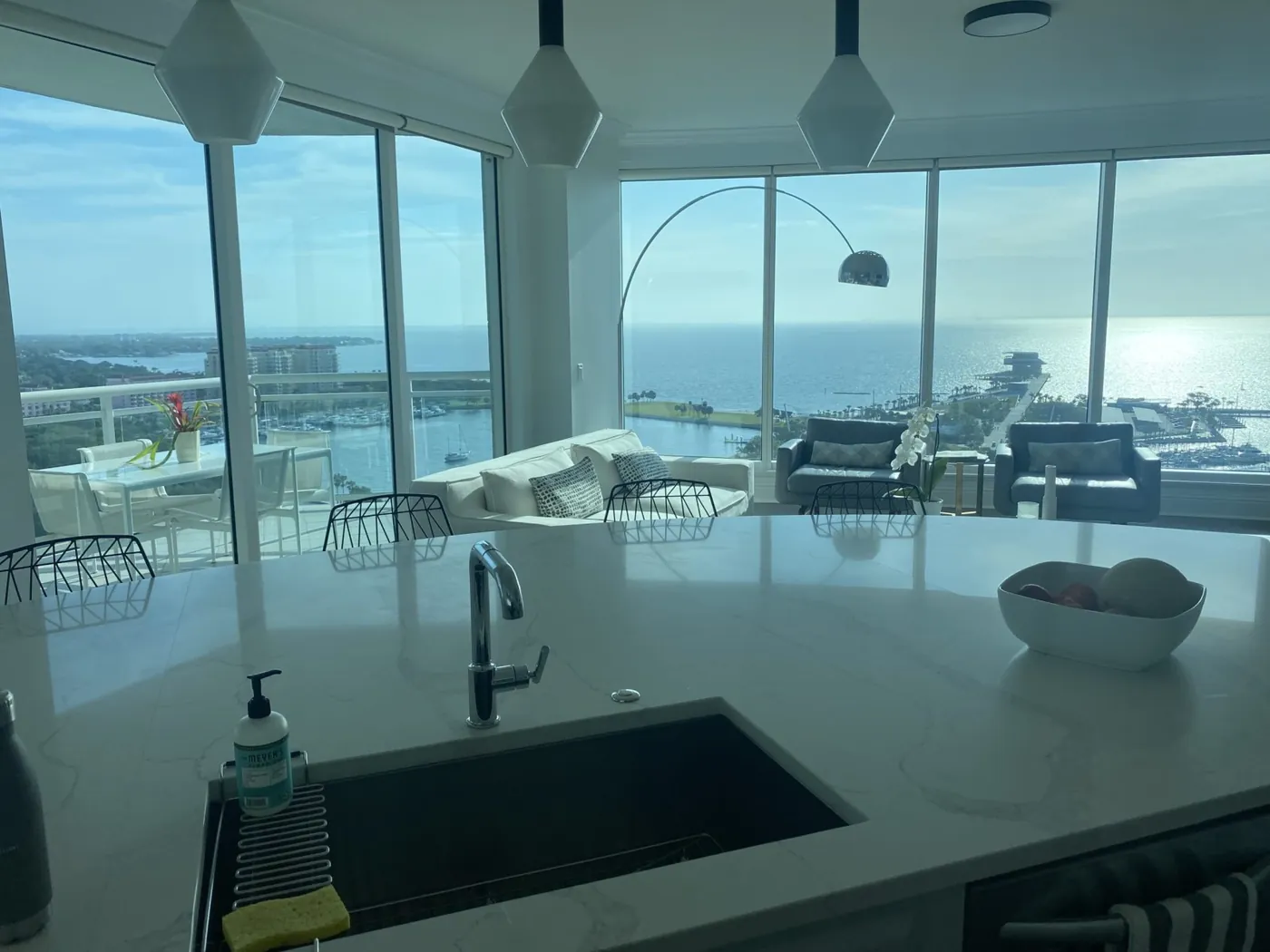 Kitchen island sink looking out over the living room and the bay